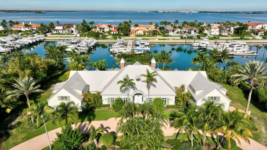 Set on a rare double lot in the prestigious, gated enclave of Sailfish Point, this stately home offers timeless
presence and exceptional waterfront potential-approx 230 ft on the water and dock that may accommodate a large
vessel-this is a boater's paradise! Grand curb appeal leads to a main residence offering 5 bedrooms, 5 full and 2
half-baths, within 7,020 sf of living space. A dramatic great room with fireplace, ideal for elegant gatherings, is
enhanced by a marble foyer, volume ceilings, and formal dining room. The kitchen features an island, gas cooktop,
and casual dining, opening to a family room and Florida room. Two separate 3-car garages are crowned by two
private guest apartments, each with bedroom, bath, living area, and kitchen. Sailfish Point delivers an unparalleled resort lifestyle with an oceanfront club, dining, tennis, pickleball, Nicklaus Signature golf, fitness center, spa, full
service marina, helipad, 1.5 miles of pristine beach, and exceptional private security