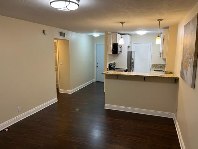 Rare corner unit in the center of everything retail on US1. This cozy 1 BR condo is completely renovated with tankless water heater, new AC, new kitchen, new bath, washer/dryer stack, new flooring, and CENTRAL AC. Unlike nearly all of the other units in the building, which mostly have window AC and no washer/dryer, this one is fully upgraded and ready to move in at a VERY affordable price. Great for anyone!! Easy to show. Great location, close to Lighthouse Point!