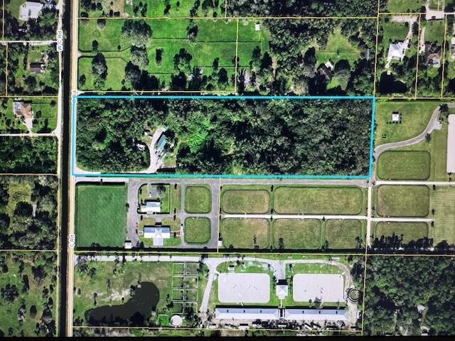 Amazing location, South of Okeechobee Blvd, old florida living, blank palette to build your family compound, horse farm, agricultural retreat, the options are endless. Large metal building to fit RV under, separate 3 car garage, shed, 2 ponds, electric, water and septic on site
