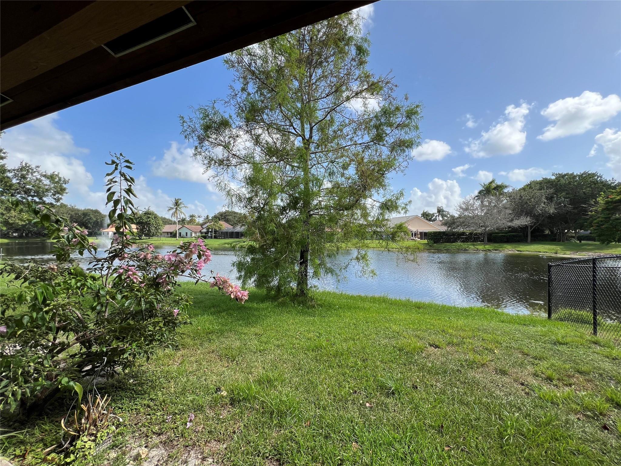 Welcome to Forest Ridge! This single-story split-bedroom home is situated on a tranquil lakefront lot in the Chapel Hill section of a highly sought-after community in Davie, Florida. Known for its beautifully & lushly landscaped neighborhood and award-winning schools, it’s also conveniently close to Nova Southeastern University, I-595, the Turnpike, and abundant shopping options. This Gardenia model is filled with natural light and boasts a freshly painted interior, bamboo wood floors throughout, impact windows, a newer roof 2019, 2020 water heater, and updated a/c 2024. Highlights include a spacious covered south facing back patio that's perfect for dining al fresco with friends and family, a brand-new master bath, updated kitchen and guest bath, and an open floor plan w/vaulted ceilings.