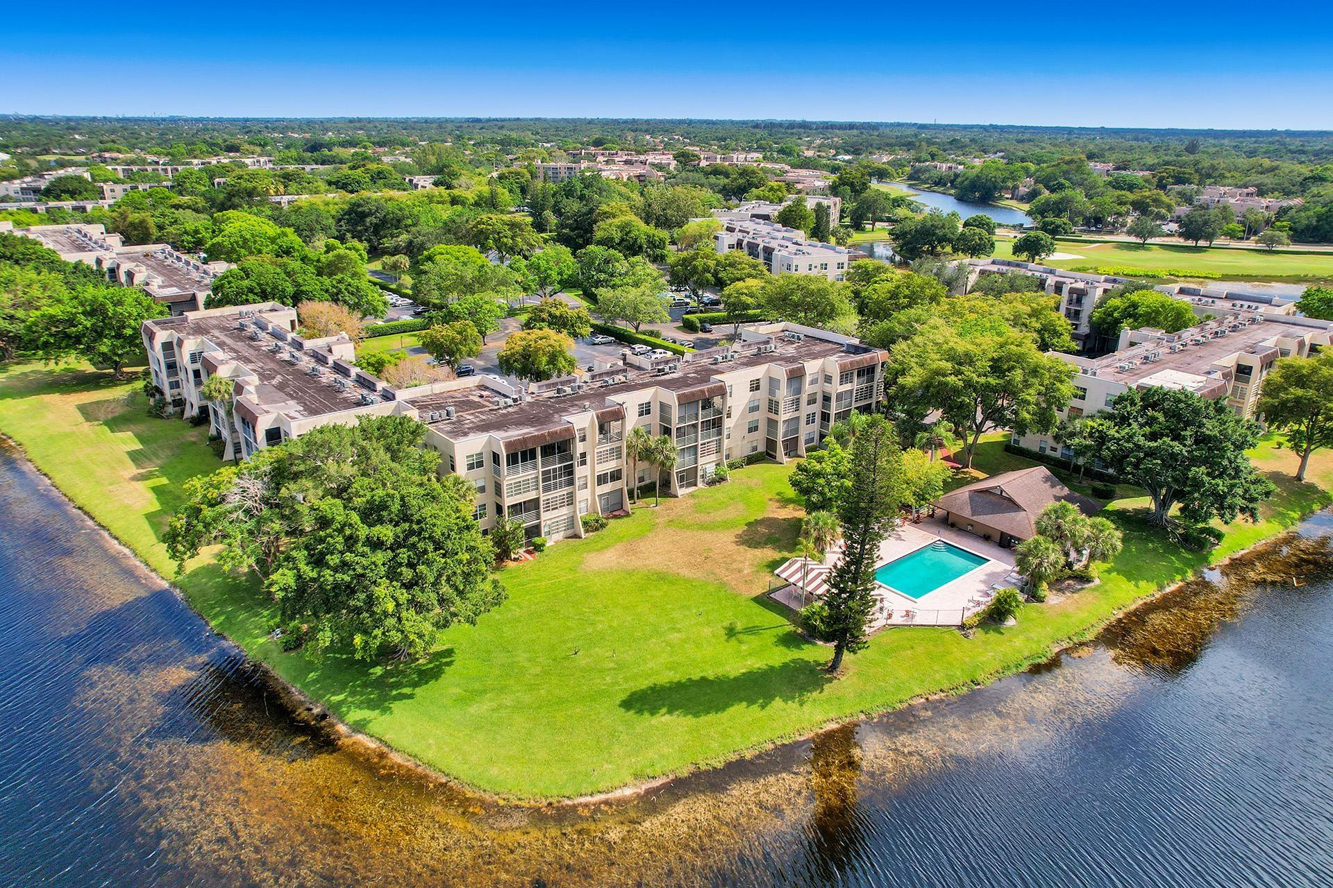 COZY 2 BEDROOM(2ND BEDROOM HAS AN ACCORDION PARTITION WALL) WITH STUNNING WATER VIEWS FROM SCREENED PATIO* MOVE IN READY*POSSIBLY TURN KEY AS FURNITURE IS AVAILABLE* IMPACT WINDOWS THROUGHOUT* NEW AC 2023, LOW USAGE SNOWBIRD APARTMENT LOCATED IN PRIVATE PINE ISLAND RIDGE COUNTRY CLUB. CLUB AMENITIES INCLUDE EXECUTIVE GOLF COURSE, TENNIS, PICKLEBALL, BASKETBALL, BOCCE BALL, CHILD PLAYGROUND, SWIMMING POOL, SAUNA, STREAM, GYM, CHIPPERS SPORT BAR WITH RESTAURANT, LAKEVIEW DINING ROOM INCLUDED WITH MAINTENANCE* BUILDING HAS NEW ROOF INSTALLED IN 2023 AND IS PAID IN FULL *NO LEASING PERMITTED. PARKING SPOT 4-47