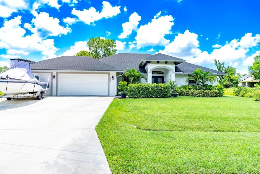 Welcome to your own piece of paradise in Port St. Lucie! This immaculate 2021 4-bedroom home by Grande Construction offers stunning tropical curb appeal with manicured landscaping and a grand columned entrance that immediately sets a tone of elegance. Features include impact windows & doors, custom coffered ceilings, crown molding, tile flooring in main areas, and a spacious master suite with custom closets and a large tiled walk-in shower. The gourmet kitchen boasts wood cabinets, quartz countertops and backsplash, and under-cabinet lighting. Enjoy outdoor living at its best with a heated, salt water pool and a summer kitchen/tiki bar with two refrigerators and built-in grill--perfect for entertaining and enjoying the Florida lifestyle. Impeccably maintained and move-in ready!