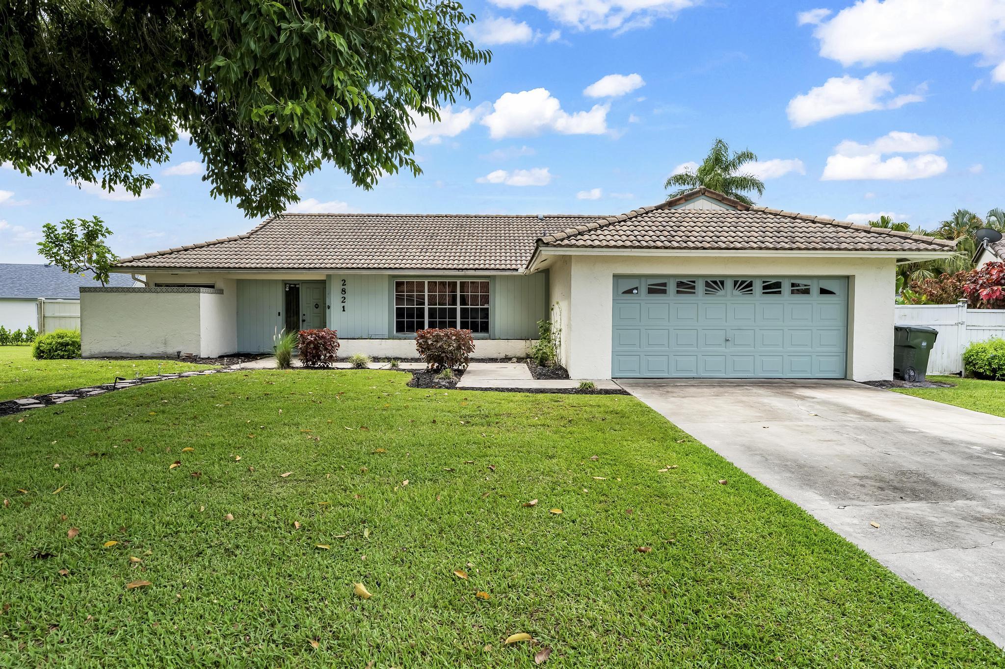 Welcome to this beautiful 3-bedroom, 2-bathroom pool home, perfectly tucked away on a quiet cul-de-sac! From the moment you arrive, the long driveway offers ample parking and leads to a spacious 2-car garage. Step inside to find vaulted ceilings and stunning wood-look tile flooring flowing seamlessly throughout most of the home. The tongue-and-groove ceiling in the kitchen and family room adds warmth and character, while updated fixtures bring a modern touch. The open living and dining areas create a bright, airy feel, perfect for entertaining or relaxing. The utility room houses the laundry area, complete with a sink for added convenience. The primary suite is a private retreat featuring double vessel sinks in the en-suite bathroom, providing both style and functionality.