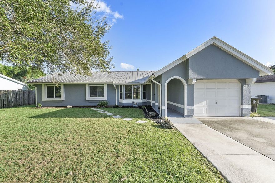 Welcome to this beautifully updated 3-bedroom, 2-bath gem perfectly situated in the heart of Port Saint Lucie. Combining modern style with everyday comfort, this home offers a bright, open layout that feels both inviting and spacious ideal for relaxing or entertaining guests.The stunning kitchen is the centerpiece of the home, featuring sleek quartz countertops, stainless steel appliances, and abundant cabinet space for all your culinary essentials. Whether you're hosting a dinner party or enjoying a quiet meal at home, this space is designed to impress.