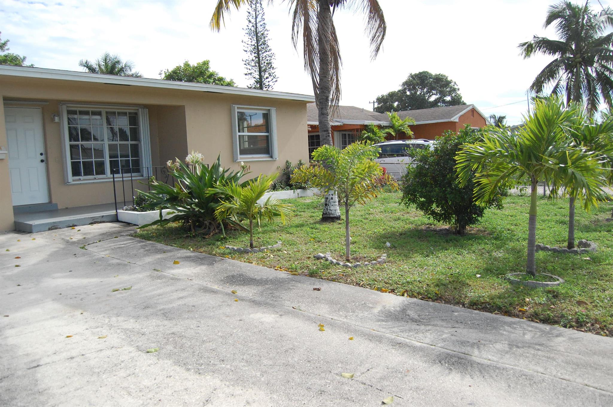 Lovely, Spacious 2 bedroom, 2 bath, plus den, home. Freshly painted inside. This home has it all: granite kitchen counters, central AC, washer and dryer, engineered wood flooring, 2 car driveway, accordion storm shutters, covered front porch, open rear patio, large backyard. Close to I-95, downtown Lake Worth Beach, Palm Beach State College and more. Garage and shed NOT included in rental. Don't miss the opportunity to make this beautiful home yours.