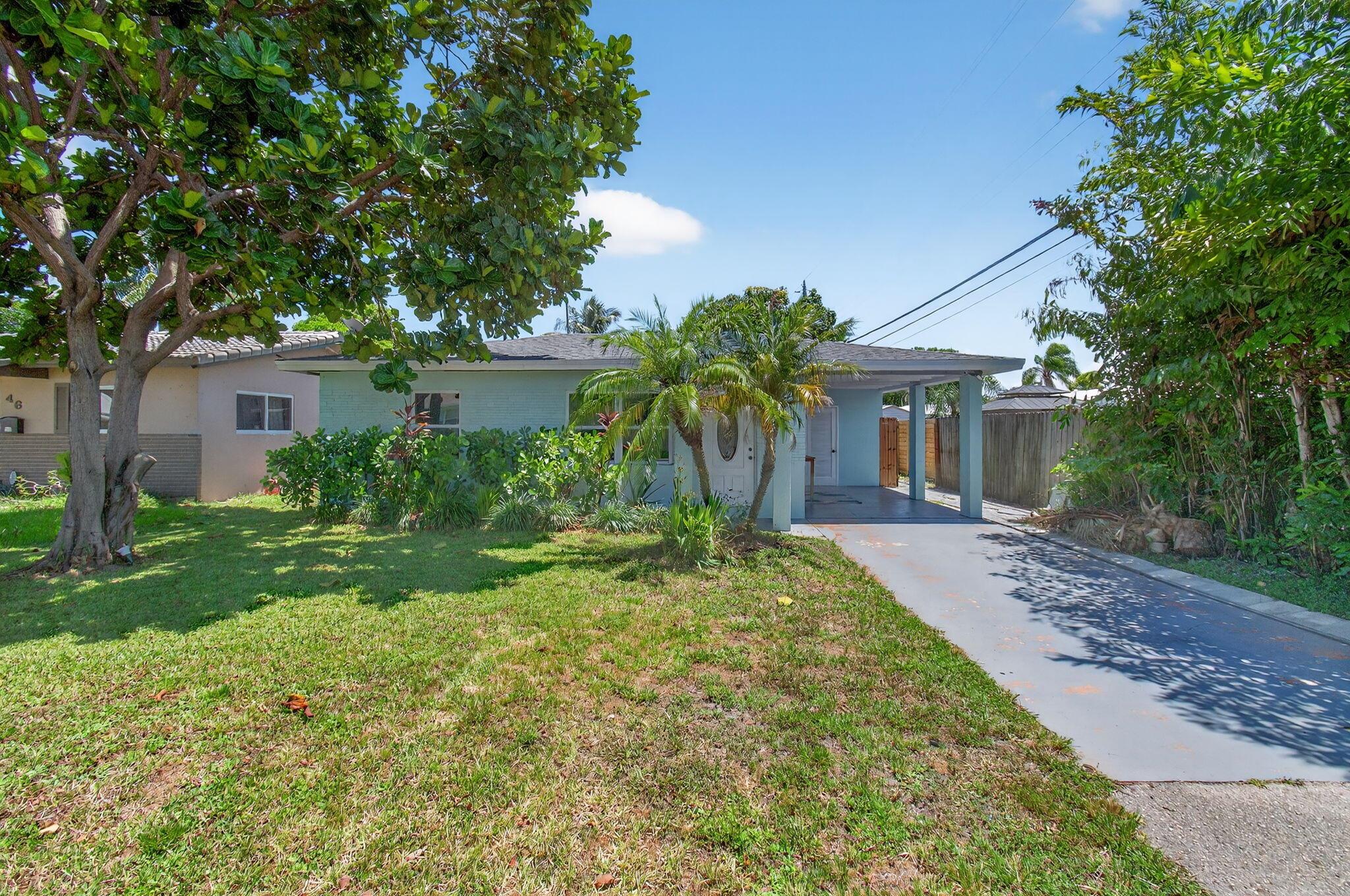 Charming Mid-Century Ranch-style home located just 10 minutes from Lauderdale-by-the-Sea! This single-story property has been thoughtfully updated with a new roof (2024), impact windows (2024), new insulation (2024), and tile flooring throughout. The bathroom was completely renovated in 2023 with a new vanity, tub, and toilet. A spacious den offers flexibility and can easily be converted into a third bedroom. The large fenced yard features an outdoor shower, perfect for Florida living, and there's a full irrigation system across the property. Washer and dryer (2023) are also included. Ideal as a primary residence, vacation retreat, or investment property in Oakland Park's growing market!