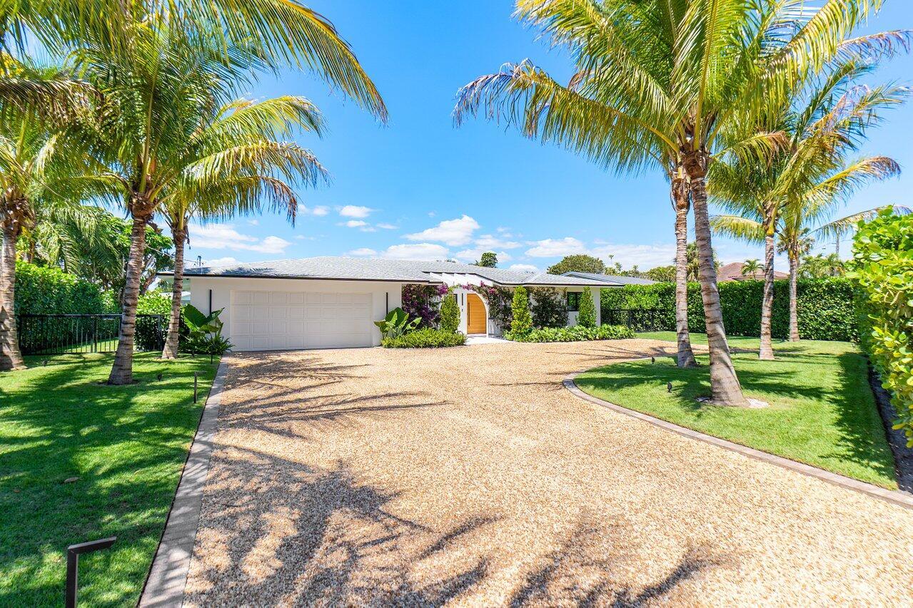 Welcome to this exquisitely renovated residence located in the highly desirable community of Lake Clarke Shores. Designed with exceptional craftsmanship and premium finishes throughout, this waterfront home offers a perfect blend of luxury, comfort, and functionality. As you arrive, you're greeted by a striking pivot entry door and a beautifully landscaped entrance framed by coconut palm trees. Inside, the home features full impact windows and doors, sleek frameless interior doors, and a light-filled open layout that exudes modern elegance. The chef's kitchen is a true masterpiece, showcasing high-end Miele appliances, pristine white stone countertops, and custom wood finishes--making it both a functional and visually stunning space.