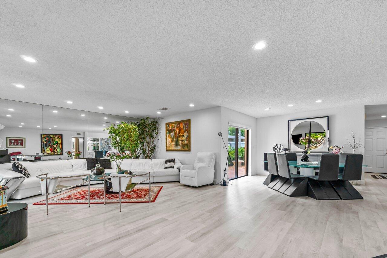 Situated within the serene park-like settings of Westgate at Hunters Run Country Club, this spacious downstairs corner condo features 1778sf of living space, with water views, 2 bedrooms, 2 updated baths, and a convertible living space that can be easily configured as a den or 3rd bedroom. Other highlights include luxury vinyl plank flooring, recessed LED lighting, glass enclosed Florida room, newer washer and dryer, zebra-style window shades, outfitted walk-in closet and an open-air patio perfect for outdoor dining and golf cart parking. Residents of Hunters Run enjoy three 18-hole championship golf courses, 18 har-tru tennis courts, 12 pickleball courts, resort-style clubhouse, pool, salon & spa, fitness center, six dining venues and so much more. *Mandatory annual membership*