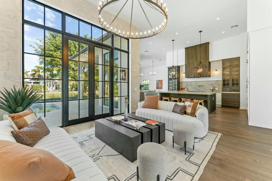 Step into a masterfully reimagined 3-bedroom, 3-bathroom residence in the prestigious Palm Beach Polo community. Completely redesigned and gut-renovated with top-tier materials, this exquisite home offers an unparalleled blend of sophistication and comfort. Two versatile flex spaces provide endless possibilities--ideal for a home office, formal dining, den, or guest suite. The coveted natural light floods in through 12-foot windows and doors, accentuating the rich dark wood floors and striking natural limestone accent walls. A chef's dream kitchen boasts Thermador appliances and real brass fixtures, ensuring every detail exudes luxury.Nestled on a quiet, tree-lined street, this home features an excellent split floor plan for privacy and ease of living.