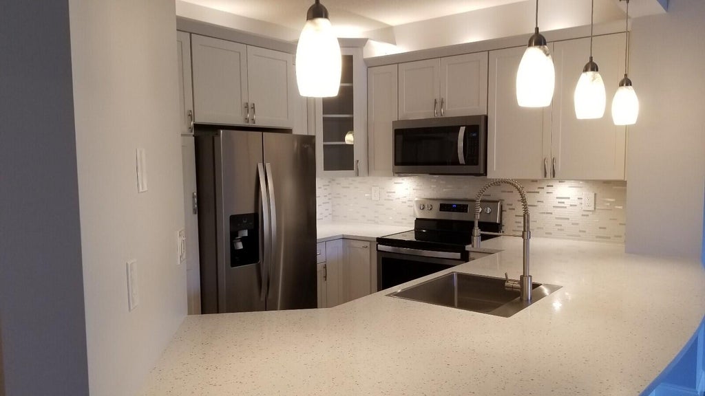 Photo of 300 UNO LAGO Drive #103, Juno Beach, FL 33408 (MLS # B26082278)