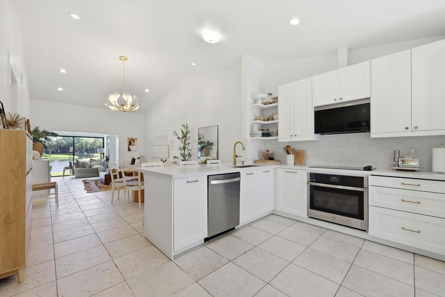 Move right into this conveniently located Central Boca villa! Beautifully renovated and perfectly positioned with long lake views, this bright home features an open floor plan with vaulted ceilings that create a spacious, airy feeling. The modern kitchen and updated finishes make everyday living comfortable. Enjoy the added convenience of a dedicated laundry room and an additional living space-perfect for a home office or den. Large windows bring in plenty of natural light, showcasing the peaceful water views. Located in an all age community with low association fees, featuring fantastic amenities such as a pool, tennis courts, and a clubhouse including arcade, games, and  billiard. A wonderful opportunity to enjoy South Florida living in a beautifully updated home in beautiful Boca Raton.