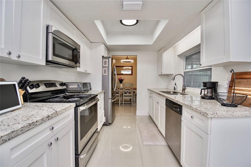 Discover this impeccably updated 2BR/2BA single-family home where modern luxury meets functional living. Step inside to find over 1300 square feet with sleek tile flooring throughout, with a beautifully renovated kitchen and updated bathrooms that radiate contemporary style. The flexible floor plan features an enclosed Florida Room, perfect as a home office, gym, or den. Practicality is a priority here, with a dedicated laundry room, extra storage room, a garage, and a large driveway fitting up to 6 cars. New Roof in 2021.Enjoy a vibrant lifestyle in a well-maintained community boasting 2 pools and a large clubhouse for just $45/month (paid quarterly). Centralized location near the Turnpike, Parks, and Shopping. Don’t miss out on this gem! Call the listing agent today for a private tour.