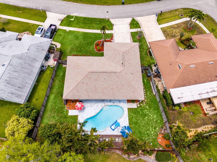 New A/C with transferable warranty through 2035, Hurricane Impact Windows, Heated Pool, Roof 2021 and a prime Wellington location with no HOA — conveniently located near parks, shopping, dining, Wellington's equestrian venues, and highly rated schools. This 3BR/2BA pool home features vaulted ceilings, ceramic tile flooring throughout, a split-bedroom layout, and bright open living spaces designed for both comfort and entertaining. The spacious kitchen flows seamlessly into the breakfast area and family room, creating a functional and inviting layout. Step outside to a fully fenced backyard with generous outdoor space ideal for relaxing or entertaining year-round. Additional highlights include a 2-car garage. Some photos have been virtually staged. Sprinkler system currently not operation