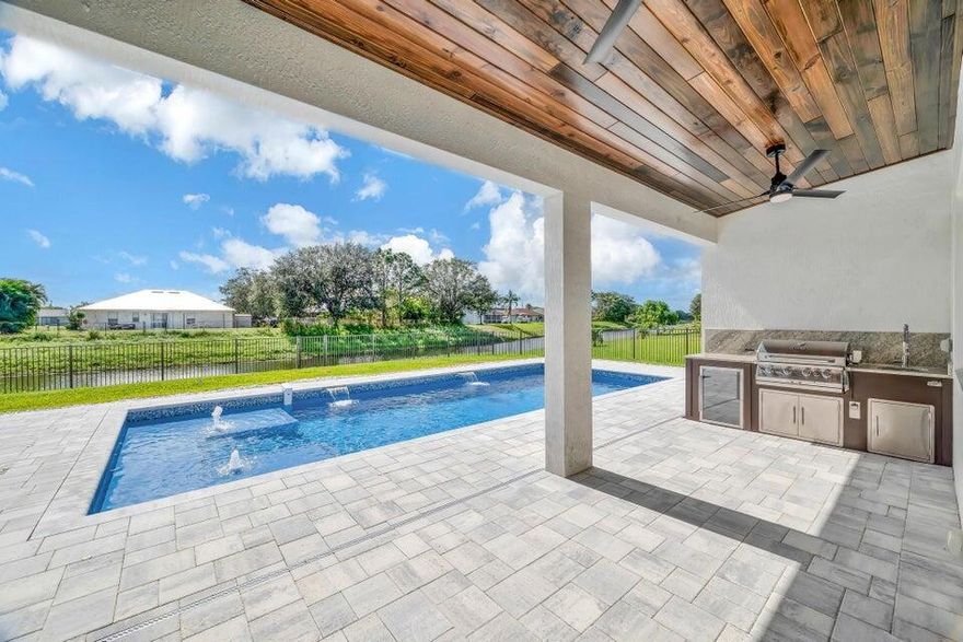 Spectacular BRAND NEW POOL HOME in prime location on the Treasure Coast ! 4 bedroom + DEN/ 3 bath / 2 car garage and BRAND HEATED NEW POOL . This house features all bells and whistles: wood like tile, gourmet kitchen, OPEN PLAN LIVING AREA, TWO MASTER SUITES, 2 car garage, outdoor kitchen, salt water heated POOL ,SUMMER KITCHEN and FENCE! Enjoy Florida outdoor living in this amazing pool home overlooking the canal. IMPACT GLASS WINDOWS THROUGHOUT! Minutes to TRADITION & MET STADIUM .Easy access to main roads, short drive to the beach. Lawn care and irrigation and indoor PEST control included in the rent price. Probably one of the nicest homes in the area with no HOA. Note this is unfurnished rental . Also available for FURNISHED SEASONAL RENTAL, minimum 3 months @10k a month in season.