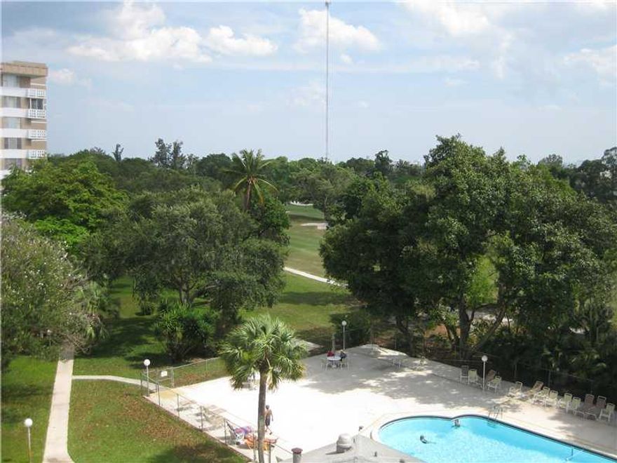 Elegant 2/2 corner deluxe condo, approx. 1500 sq. ft. The unit is enhanced with amazing tropical views of palm trees, the golf course, heated swimming pool, the perfect balance of sunshine and shade. Within the unit, ceiling fans by Fanimation, tinted win dows, furnishings are available to purchase and are in pristine condition, coffee tables are lucite, wall décor of professionally framed prints by Monet, and Van Gogh. The building boast 24 security, assigned parking conveniently located.