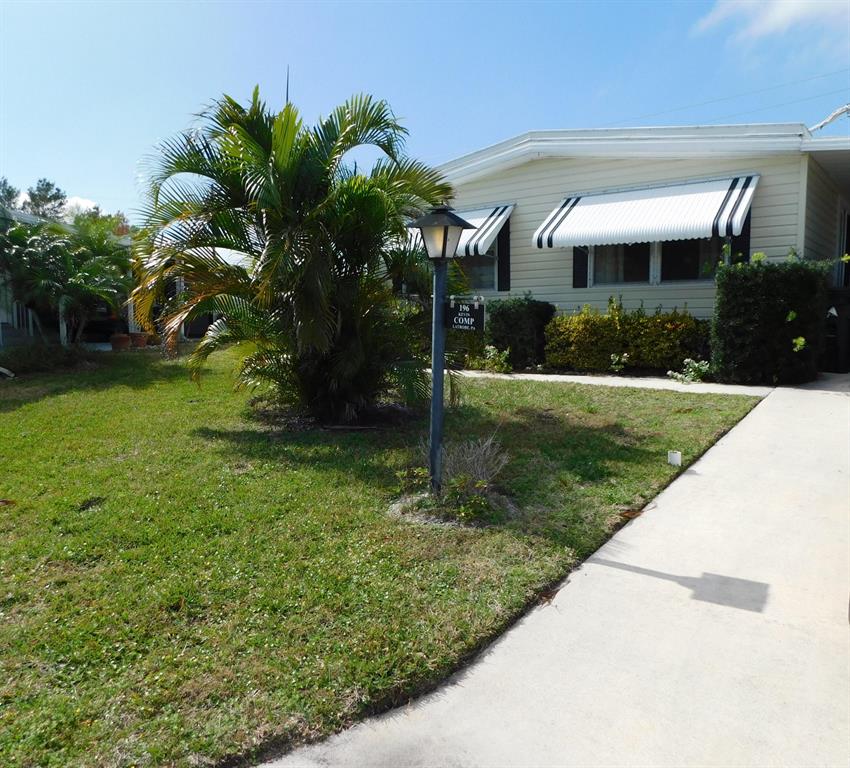 Beautiful upgraded home in Pinelake Village! 2 bedrooms, 2 baths, a HUGE workshop/shed area with golf cart storage space! Newer roof, AC, floors, and bathrooms! Pinelake Village is a 55+ ''lot rent'' community in Jensen Beach, close to everything!