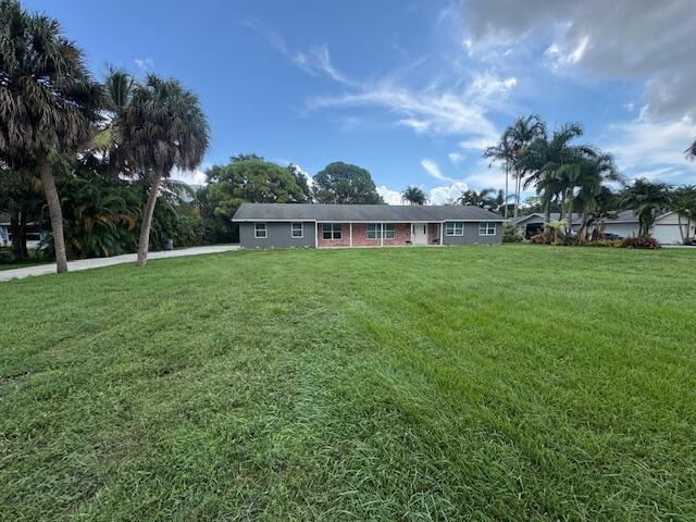 ''Exceptional opportunity in the heart of Palm Beach Gardens! Situated on 1 acre (.97) of prime real estate, this property is being offered at lot value with NO HOA. The existing 2-bedroom, 2-bathroom CBS home with a 2-car garage is a handyman special, perfect for those looking to renovate or tear down and build their dream home. Enjoy a spacious lot with endless possibilities, located just minutes from the Gardens Mall, world-class golf courses, stunning sandy white beaches, and an array of fine dining options. Don't miss out on this rare chance to create your ideal living space in a highly desirable location!''