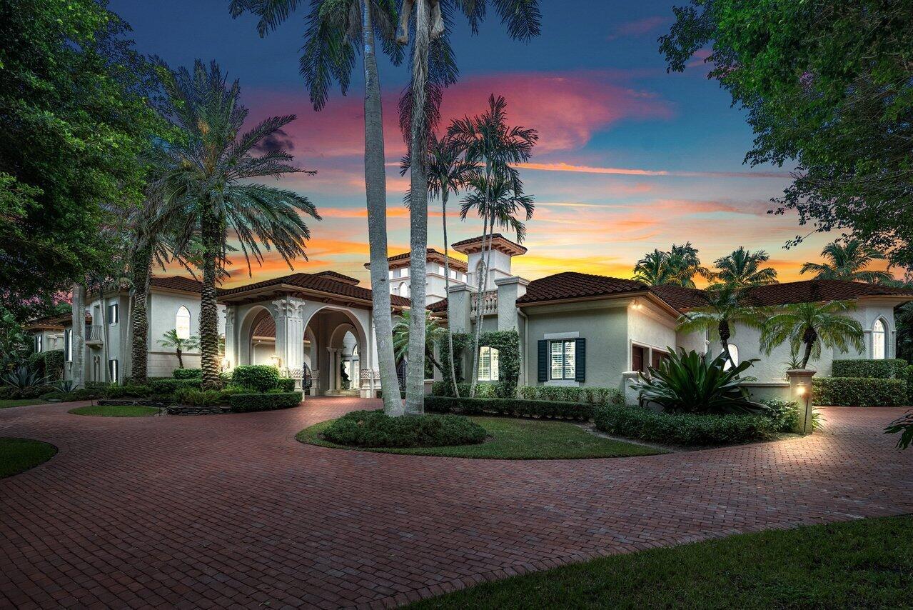 Breathtaking banyan trees welcome you to this majestic mediterranean lakefront estate boasting 10,013 square feet of living space and set on over an acre of meticulous and professionally designed landscaping. 8465 Twin Lake Drive is in a league of its own showcasing unparalleled luxury in one of Boca Raton's most coveted and exclusive neighborhoods, Long Lake Estates. Designed for exquisite living and entertaining on a grand scale this custom sprawling property with extraordinary architectural details are evident in arched doorways, barrel and coffered ceilings, stone columns and custom millwork. Featuring 7 oversized ensuite bedrooms including a guest house, staff quarters or in-law suite, 3 half bathrooms, club room with bar, home theatre, office and chef's kitchen this home is