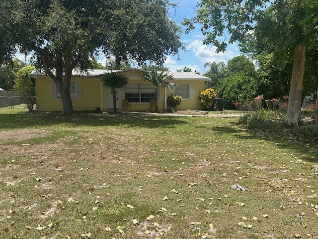 Great neighborhood for all ages in outstanding location near the quaint riverside downtown Stuart, beaches, and shopping. Split bedroom plan with spacious eat in kitchen, large laundry room with washer and dryer hook up, shelving, cabinet and sink. Oversized fenced yard with storage shed, plenty of room for pool, garage, etc. No restrictions, bring your pets, kids, RV and boat. Newer roof and newer sewer.