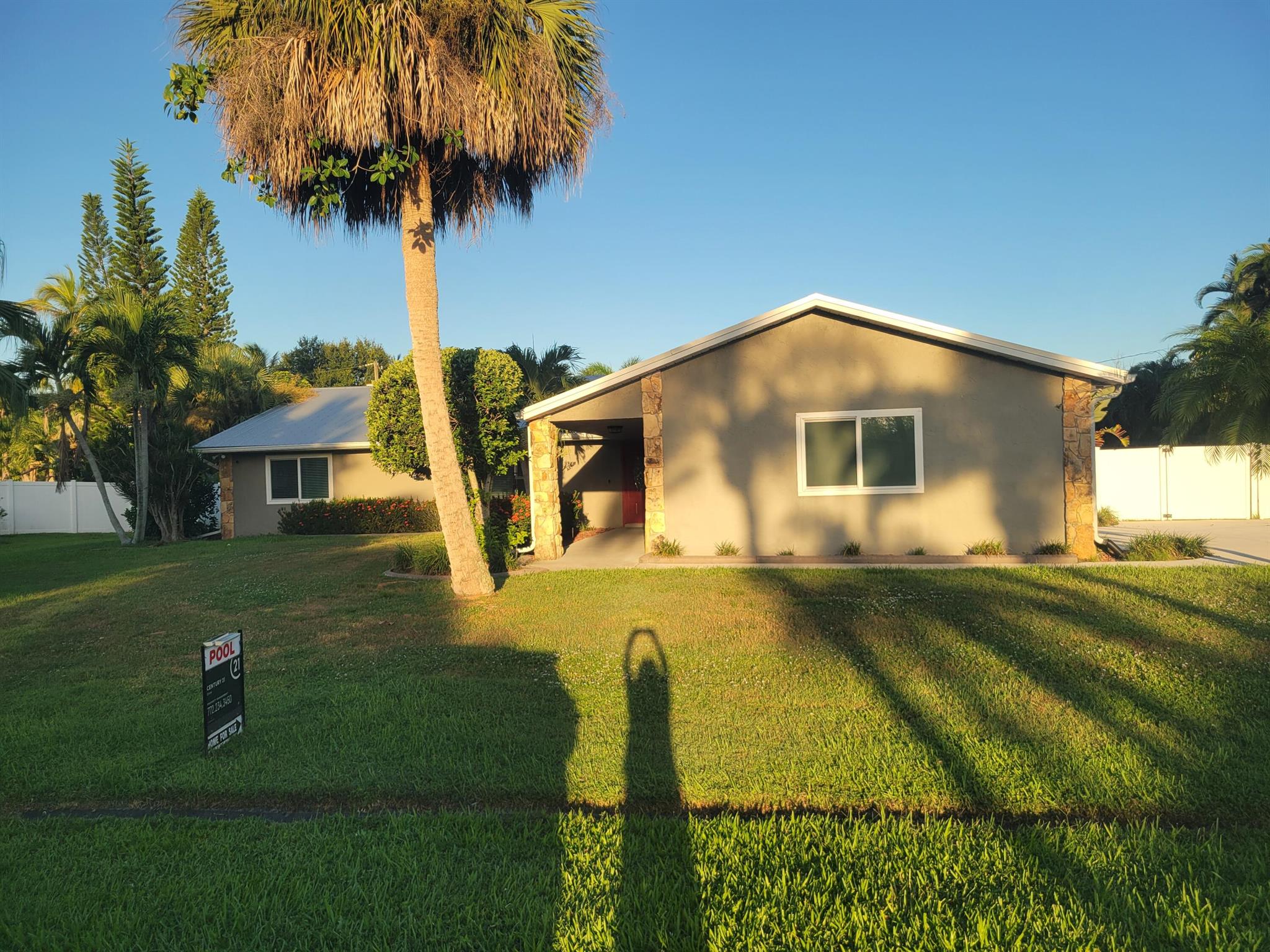 Lovely updated 3 bedroom/2 bath/2 car garage home on a 1/2-acre lot in the Sandpiper Bay area. This home boasts an open floor plan and split bedrooms. Kitchen has been remodeled with white cabinets, granite counters, stainless-steel appliances and large breakfast bar. Home has upgrades including but not limited to impact glass, fabric shutters, humidity-controlled A/C, newer metal roof, new electrical panel 2021, newer hot water heater, cathedral ceilings, wood burning fireplace, water-proof luxury vinyl flooring. Backyard has a heated salt water pool. Large, covered patio area and privacy fence. No HOA. Close to shopping and so much more.