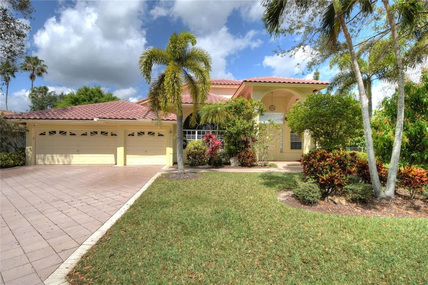 WELCOME TO THE ISLES a private estate community. From the moment you enter this 5 bedroom/3.5 home, you will feel the serenity and enjoy the beautiful landscaping that greets you every day. This courtyard home is move in ready. The unique layout allows you to enjoy the Florida sun and the outdoors. You will find high ceilings, large windows combined with an open floor plan, updated contemporary lighting, new flooring and finishes all flow into the private courtyard and pool seamlessly. Huge master suite with double walk-in closets overlooks the tropical courtyard. Guest/in-law suite with a modern bathroom and private entrance. The kitchen features granite and stainless steel and flows with the open floor plan and outdoor space. Central location, minutes to everything!