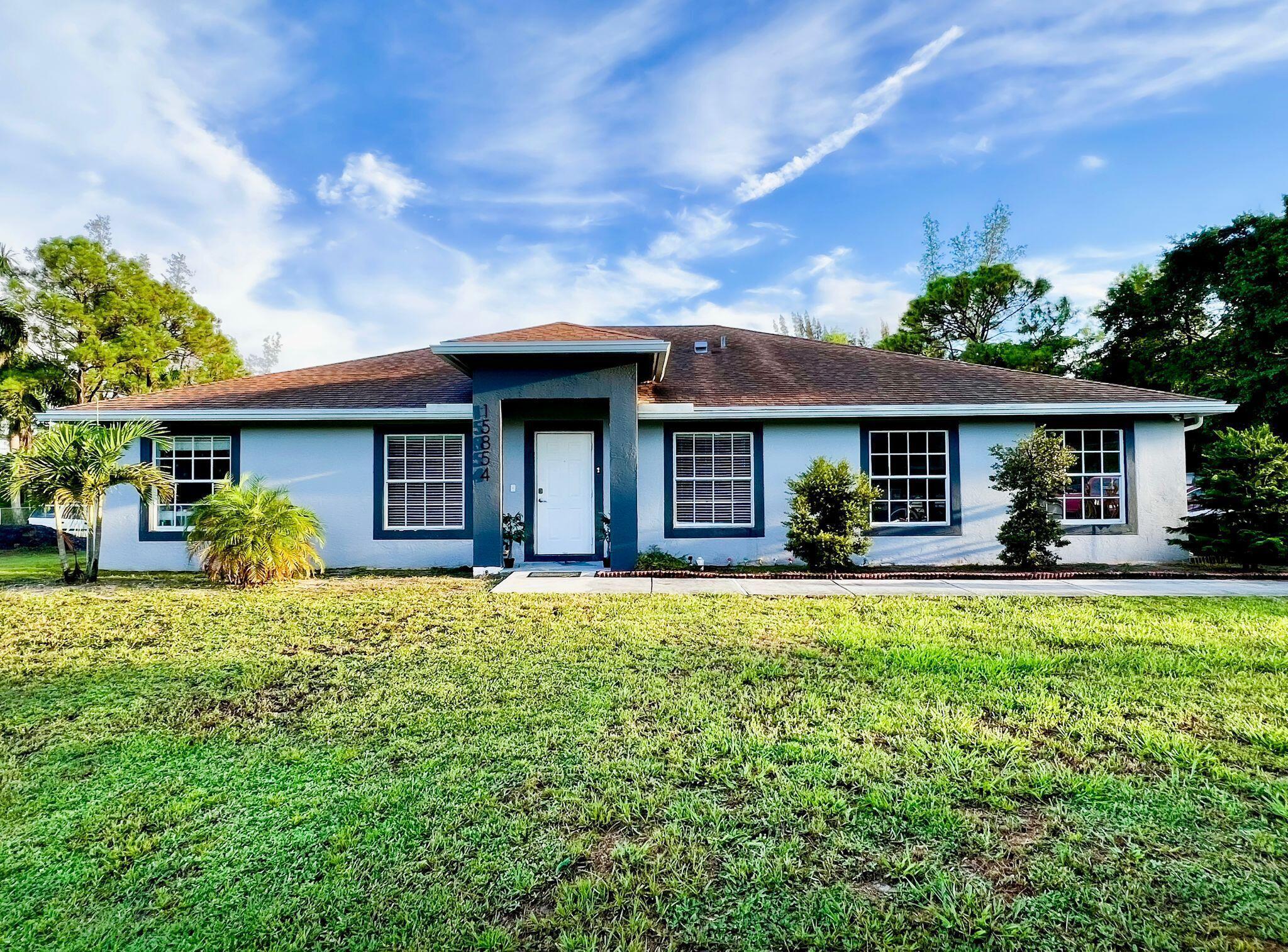 Welcome to this beautifully updated 4-bedroom, 3-bathroom home on 1.29 acres in West Palm Beach! This spacious property features an open floor plan, modern finishes, and stunning marble-look tile throughout. The home is filled with natural light, offering both comfort and style. Enjoy expansive living areas, a large front yard, and the added bonus of solar panels that will be transferred to the new owner, providing long-term savings and energy efficiency. Conveniently located with easy access to shopping, dining, and major highways, this move-in ready home is the perfect blend of privacy and convenience!