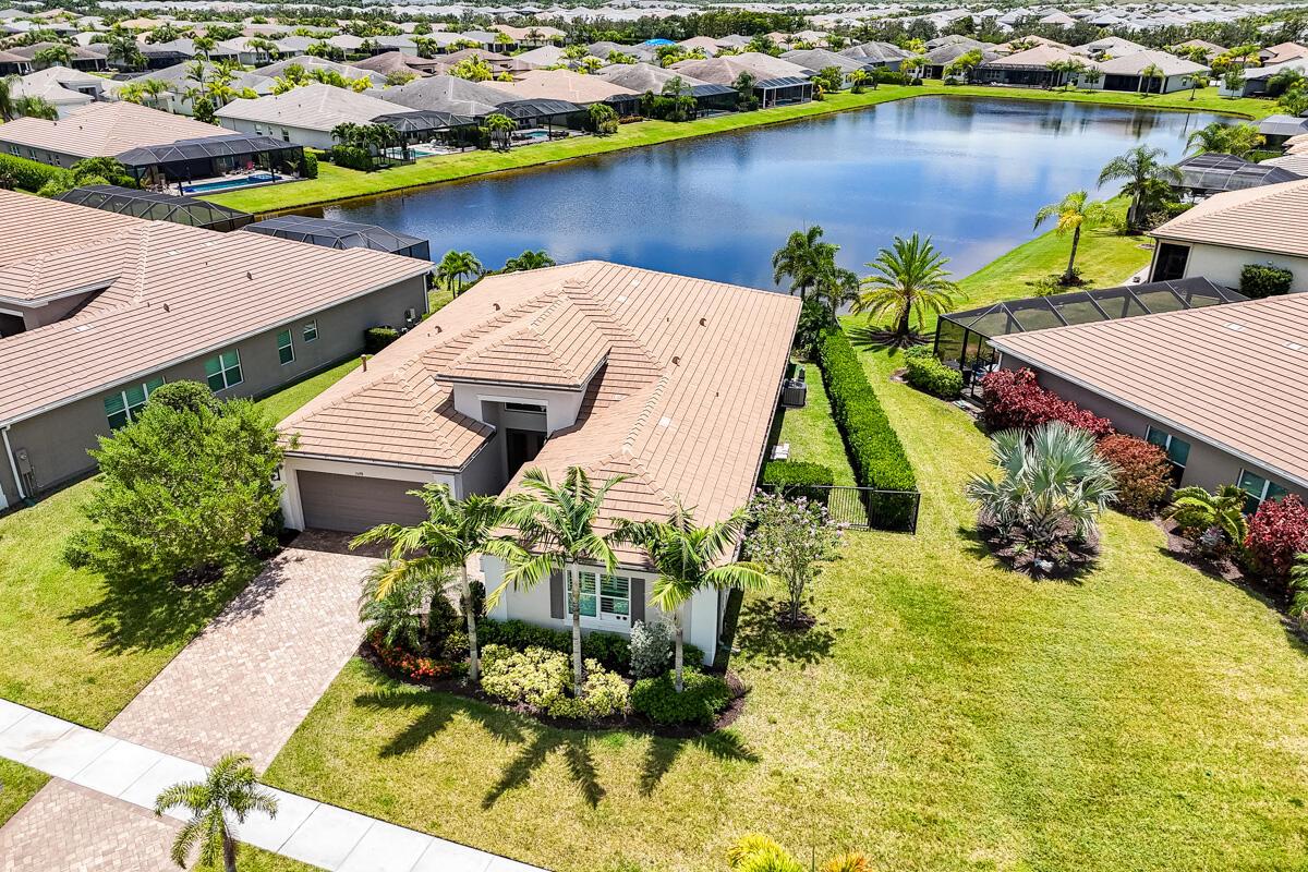 Prepare to be captivated by one of the most desirable views in Riverland. This home has countless upgrades and sits on a premium pie-shaped lot with extra yard space on both sides, lush exquisite landscaping, and expansive southern exposure over a long lake, delivering breathtaking sunrise-to-sunset vistas. Your private backyard retreat features a heated and chilled saltwater pool and spa with a natural boulder rock waterfall, in-water umbrella table with seating, sealed travertine decking, extended lanai, quartzite outdoor kitchen, built-in stainless grill, 2 electric outdoor retractable screens (1 hurricane-rated), and a cozy firepit. All surrounded by picture-perfect lake views. Inside is a chef's kitchen with level 5 cabinetry, smart-home that controls for pool, screens, and window