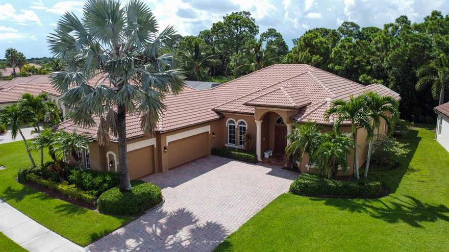 'DIVINE'' describes this beautiful 5 bedroom, 3.5 bathroom  in the Vineyards at St Lucie West located on a private reserve lot. Step inside and be amazed by the quality of this Mediterranean Designed Home. Plantation Blinds and Custom Draperies thought-out. Features include crown molding, computer work space, side load 3 car garage and tank-less hot water system just to mention some of the lovely feature included. The chef's kitchen includes 42inch cabinetry with granite counters-tops, center island, butlers pantry and wet bar. If you enjoy entertaining the large open spaces and gorgeous heated pool with screened patio/lanai is perfect for warm summer days. Quality provides piece of mind with impact doors and windows, tile roof and CBS block construction. Call for private showing..