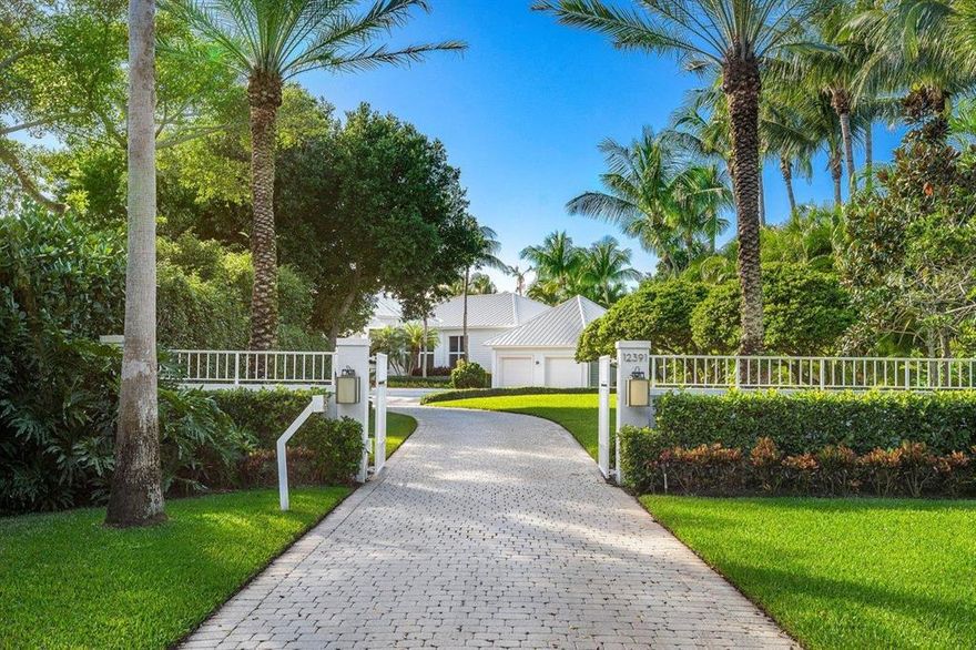 Just steps from the private community beach, this 8,916 square foot single story waterfront estate home is located in one of South Florida's finest communities, Seminole Landing. Through the 24 hour manned gate, located on Banyan Road, the home is surrounded by a canopy of trees and lush vegetation that can put anyone in a relaxed state of mind. Replete with soaring ceilings, a chef's kitchen, 5 bedrooms, 5 full and 2 half baths, this makes a perfect home for entertaining. Outside the house is where lavish meets resort with an expansive deck, a stunning lap pool, and private dock. A guest/staff suite, two separate two car garages, and a full home generator round out this exceptional offering.
