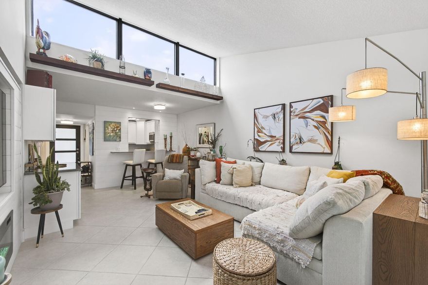 Welcome to your newly designed villa with skylights, impact glass throughout & a modern elegance that makes it a standout in the community. Recent upgrades have opened up, brightened & transformed this 940 sq ft floor plan. The kitchen features brand-new Shaker cabinets & stainless-steel appliances. The wall was opened up to the living room, with countertop space expanded, unifying the living space. In the living room, the wall-to-wall skylight brings in fantastic natural light. A dry bar has been added. Barn doors can be opened up for entertaining & closed for privacy in the convertible den between the living room & half bath. The primary bathroom has brand-new tiling, fixtures, vanity & LED-framed mirror. The half bath has a brand-new vanity & cabinets. Tile floor throughout; freshly painted; new water heater. Reverse osmosis system for clean drinking water.  Full-size new LG brand W/D in the patio, which features a back door that is convenient for a walk to the pool nearby. Two trees & beautiful landscaping highlight the outside greenery. Boundbrook is a well-maintained 55+ community situated close to the highways & Palm Beach Airport, as well as shopping on 10TH AVE & CONGRESS AVE. This is a quiet neighborhood & the villas offer more privacy than condo living. Close to Publix; downtown Lake Worth & downtown West Palm Beach are both nearby as well. There is a 1-car maximum for this unit.