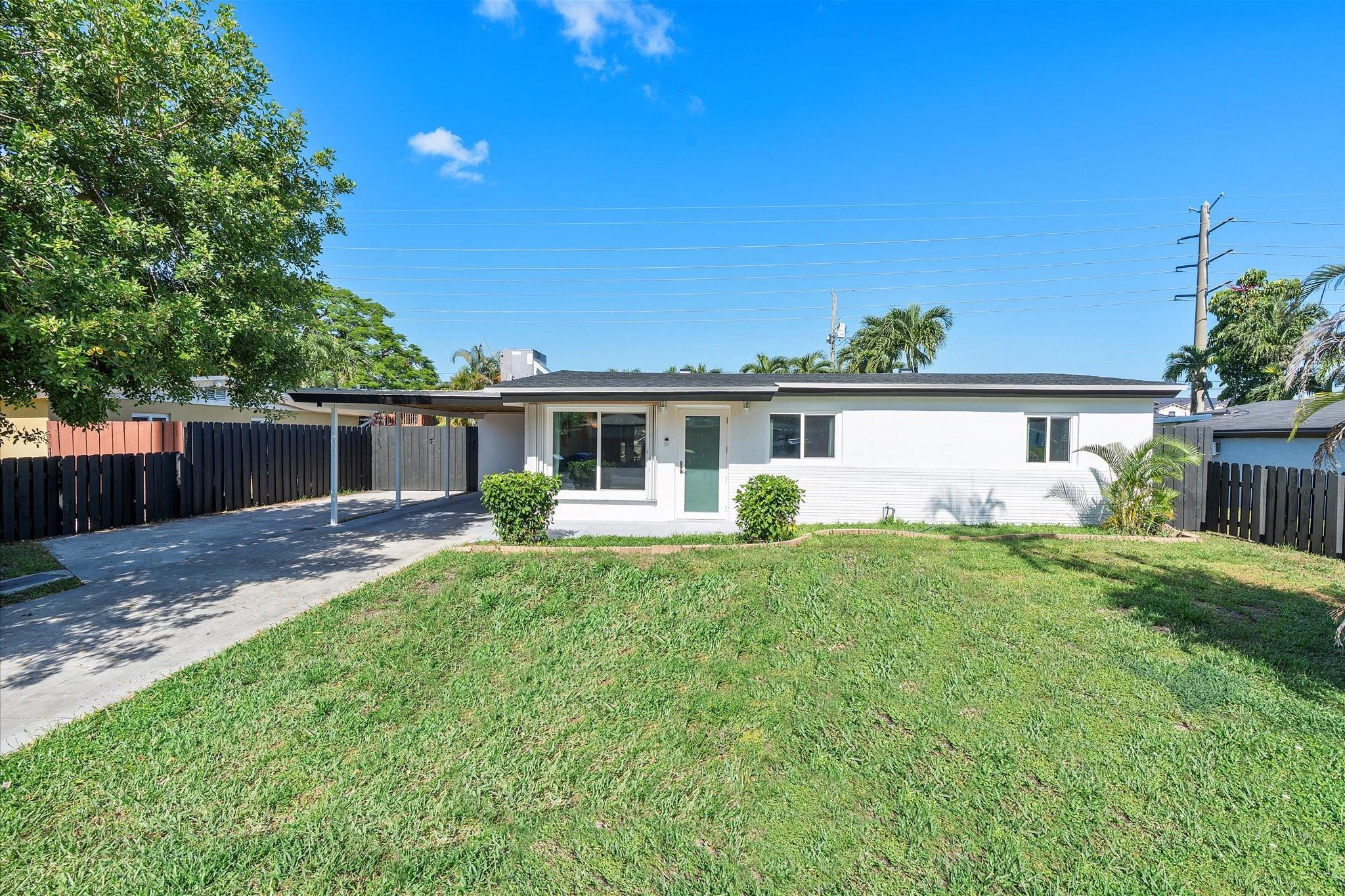 Beautifully updated and move-in ready, this charming home features tile flooring throughout, recessed lighting, upgraded baseboards, and a neutral color palette that adds brightness to every room. The open kitchen and living spaces flow seamlessly, while the bathroom boasts floor-to-ceiling tile, new toilet, vanity, mirror, and lighting (2024) for easy maintenance. Outside, enjoy a lushly landscaped fenced backyard oasis with an inground pool, child safety fence, and open patio. A carport and extra gated parking pad accommodate cars, boats, or toys. NEW roof (2025), A/C (2017), hurricane windows/doors (2017), and new pool filter canisters (2024). Full-size washer/dryer. No HOA—ideal as a primary home or investment. Convenient to Hardrock, shopping, dining, and schools.