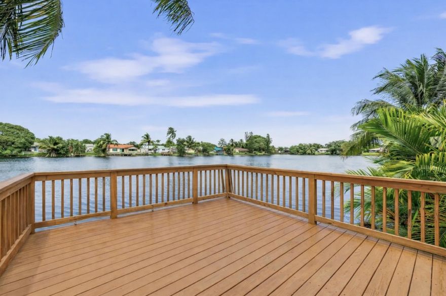 Welcome to this beautiful lakefront home in Palm Aire Village. Set on lush landscaping, it features neutral tile flooring, impact windows and doors, and a bright, airy feel. The open layout offers spacious living and dining areas flowing into an updated kitchen—perfect for everyday living and entertaining. Both bathrooms are updated, including a serene primary suite with a walk-in shower and lake views. The primary bedroom opens to a private courtyard for a peaceful escape. Enjoy a resort-style backyard with water views, heated pool, expansive deck, pergola, and dock. Additional features include new A/C, newer roof and water heater, garage, and paver driveway.