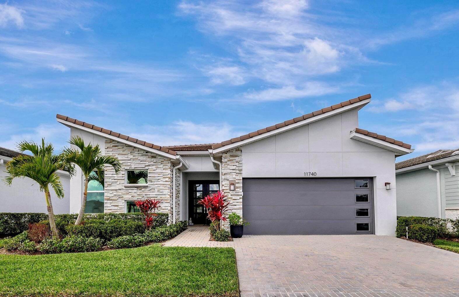 Welcome to this beautifully upgraded home in the sought-after 55+ community of Telaro at Tradition. Designed for both comfort and style, this residence features an array of high-end builder and seller upgrades that make it truly one of a kind.Step inside to find an open-concept living space enhanced by elegant tile flooring throughout--no carpet for easy maintenance. The gourmet kitchen is a chef's dream, boasting stainless steel appliances, an upgraded backsplash, quartz countertops, under-cabinet lighting, and an induction stove. The extra-large shower and square sinks in the bathrooms provide a modern touch, while the upgraded programmable thermostat ensures energy efficiency.