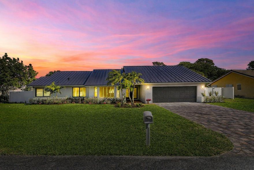 Discover the coastal elegance of this completely REMODELED 3 bed (PLUS DEN) 3.5 bath home w/ custom architectural detailing including soaring 3 level cathedral ceilings, light Italian porcelain flooring throughout & custom designer lighting fixtures. The kitchen features QUARTZITE countertops, contemporary 42" cabinetry & KITCHEN AID appliances. NEW METAL ROOF, NEW IMPACT WINDOWS, NEW A/C's, NEW SPARKLING POOL!  The Primary Bedroom has 14ft ceilings and features beautiful pool & park views. All the custom bathrooms feature porcelain tile walls & one is more beautiful than the last!  Covered patio, large backyard w/ new PVC fencing, new white travertine deck & a back gate leading to OAKMONT Park. Minutes to vibrant Atlantic Avenue & beaches