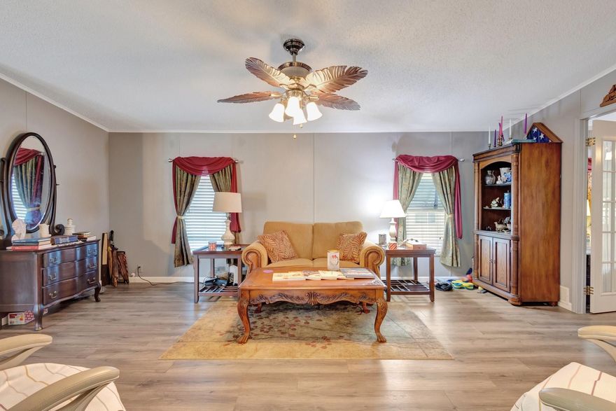 Comfort and Cozy, Welcome Home!  This inviting residence features an array of upgrades.  A spacious enclosed Florida room designed for entertaining or a great evening dinner. Inside, you’ll find a warm and welcoming dining, an open chef inspired kitchen, relaxation room in addition to a full living-room ideal for hosting guests or catching up on the best shows.  Nestled on an oversized lot, this amazing home boasts a large backyard, providing ample outdoor space for enjoying the Florida sunshine. Recent upgrades & features include wood vinyl plank flooring, remodeled bathrooms with custom vanity.  Located in an amenity rich community with a prestige 18-hole golf course, clubhouse, pools, and more with an active and vibrant lifestyle.  Your next vacation home of forever Florida Home awaits!