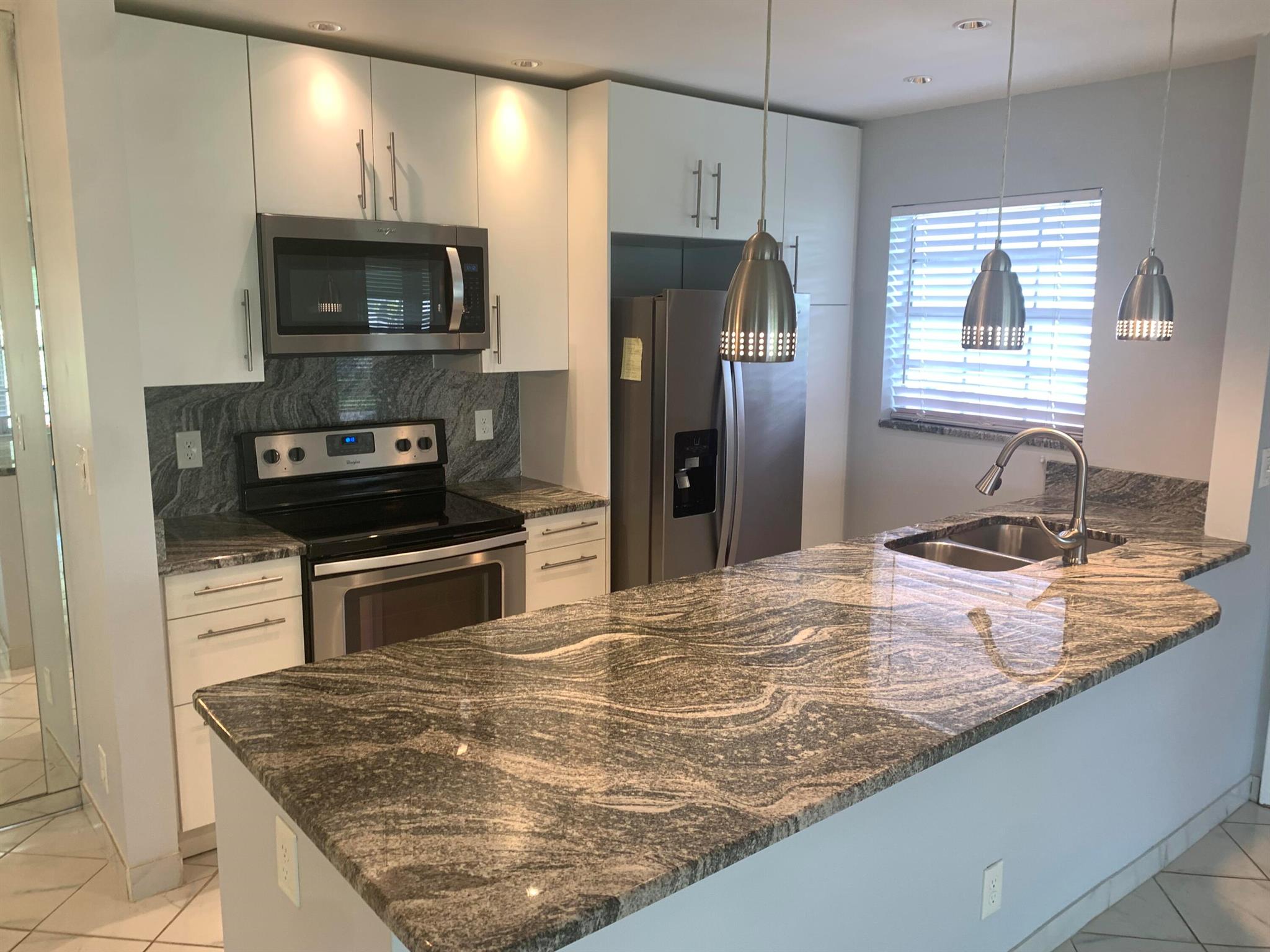 Live the life in Delray Beach in this corner beautiful villa with open kitchen with granite counters, backsplash, updated baths, freshly painted in soft gray tones, high-hat in the living, dining, kitchen, and enclosed, front Florida room. P.S. there's a washer/dryer combo in unit. Circle Terrace is a dead end street so it's in a quiet culdesac; which you can use to walk to the clubhouse from the villa. I95 is just east for quick access or go straight 5 minutes to Downtown restaurants, shops, beach and activities.