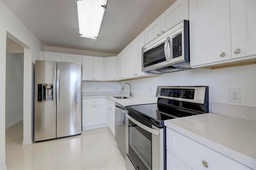 WOW! WOW! COMPLETELY RENOVATED & FRESHLY PAINTED 2 BEDROOM SPLIT FLOOR PLAN WITH WATER VIEWS! MOVE RIGHT IN! OVER $80,000 WAS INVESTED IN RENOVATIONS! THERE IS SHINY WHITE 32'' x 32'' TILE THROUGHOUT, FILTERED WATER IN THE FRIDGE, AND ALL APPLIANCES ARE LG! THE WHITE QUARTZ COUNTERTOPS HAVE A LOVELY SPARKLE FINISH! THE NEW AC IS A BOSCH & THE WATER HEATER IS A RHEEM! EACH BEDROOM HAS A WALK-IN CLOSET! THE MASTER BEDROOM OVERLOOKS THE POOL & HAS A CANAL VIEW! THERE IS COMPLETE HURRICANE PROTECTION & AN ASSIGNED CARPORT SPACE! AN ASSIGNED FLOOR TO CEILING STORAGE UNIT IS ON THE SAME FLOOR--ALONG WITH THE COMMUNITY LAUNDRY ROOM! IT IS FREE--YES--FREE--TO DO YOUR LAUNDRY--JUST STEPS AWAY! THIS CONDO IS THE LOWEST PRICED IN ORDER TO SELL SUPER QUICKLY!  THE LUCKY NEW BUYER CAN MOVE RIGHT IN!