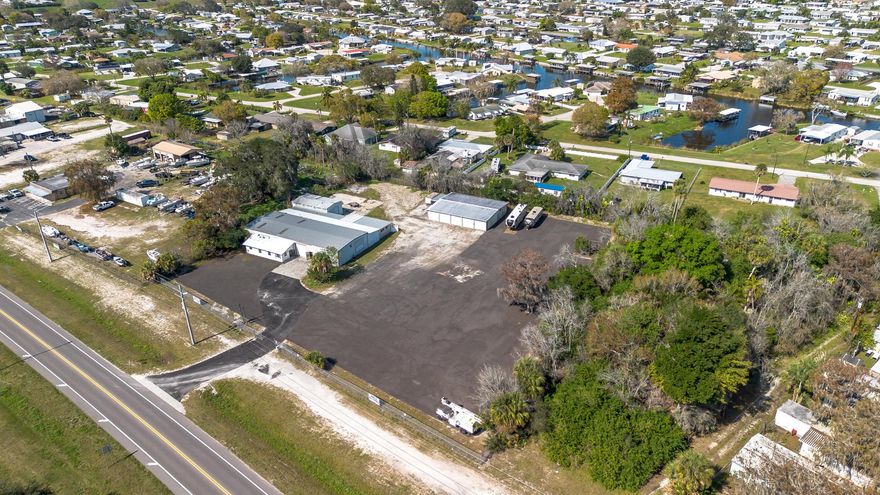 Over 2 acres of commercial property located in Okeechobee, FL with prime frontage along high-traffic US-441. The property is zoned for Vehicle Sales and Repair, allowing a wide range of permitted uses including automotive, marine, RV, trailer, motorcycle, and equipment sales, service, and storage.Improvements include multiple warehouse buildings totaling over 11,000 square feet, featuring overhead doors, high ceilings with ample vertical clearance, office space, restrooms, garage areas, and flexible interior layouts suitable for various commercial operations. The expansive site offers ample parking, outdoor storage, vehicle display, and room for future expansion.The property is currently used as a trailer dealership with boat and RV storage and and is completely fenced and gated,.