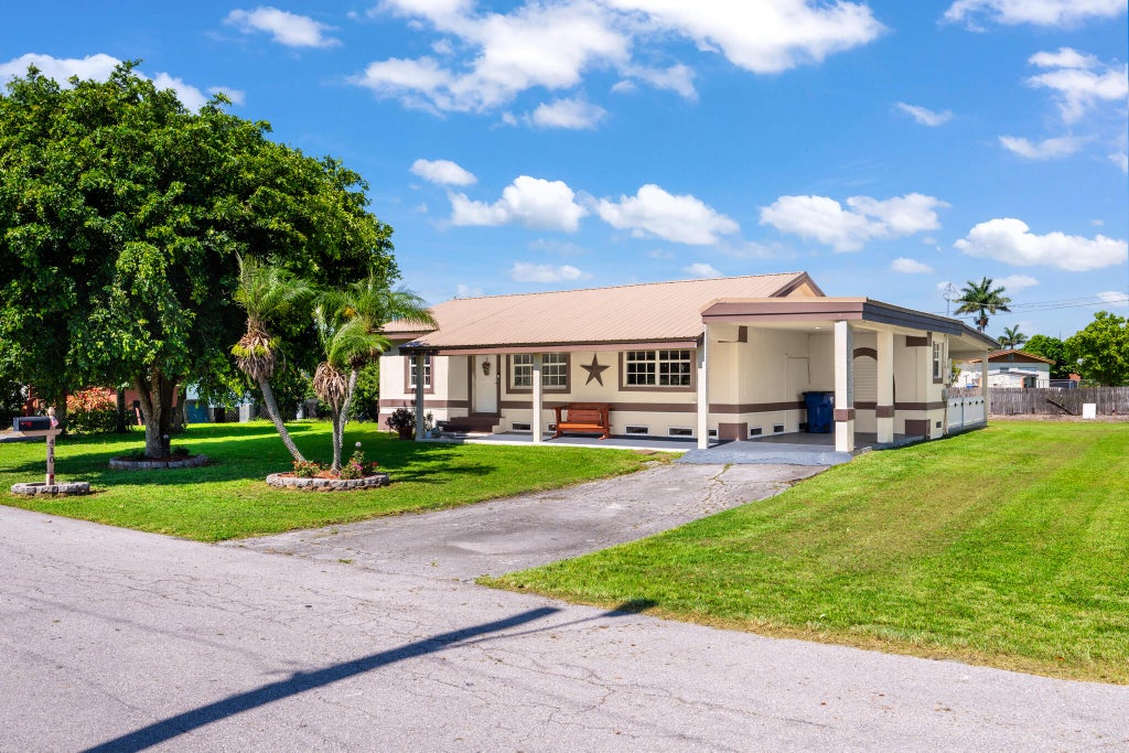 Photo of 410 SE 4th Avenue, South Bay, FL 33493 (MLS # B26041561)