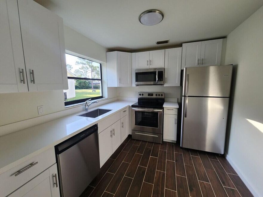 Beautifully renovated 2BR/2BA villa in the MilRace community of Greenacres. This move-in-ready home features a bright, modern kitchen with white cabinetry, quartz-style countertops, and stainless steel appliances. Open living and dining area with wood-look tile flooring and abundant natural light. Sliding doors lead to a private patio, perfect for relaxing or entertaining. Spacious bedrooms with walk-in closet and updated bathrooms with contemporary finishes, including tiled showers and modern vanities. Ample storage throughout. Conveniently located near shopping, dining, and major roadways.