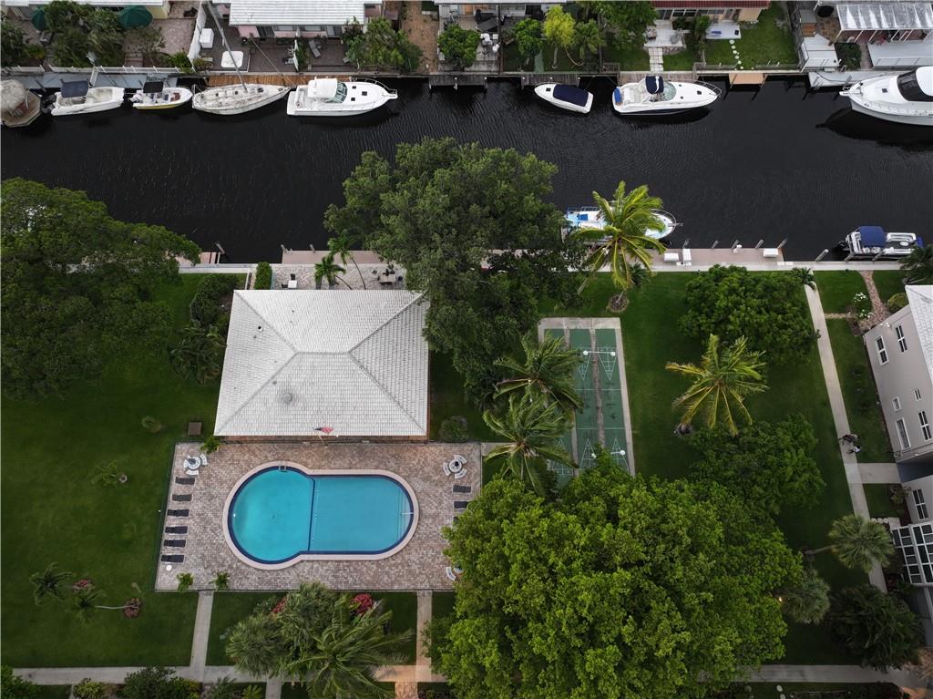 Upgraded Gray wood flooring just installed MUST SEE!! MOVE IN READY! Just minutes from Fort Lauderdale Beach. Enjoy a lovely, Top Floor View of the pool, garden, & Intracoastal/New River w/Ocean Access. Guest dock & dock rentals available. Loaded with amazing features & amenities, large open floor plan, covered parking, elevator, newer AC, impact windows, granite counter tops, large walk-in closet with attic, recessed lighting, stainless steel appliances, large free laundry facility, extra storage room, gated entry, outdoor gas BBQ, heated pool, 24hr security cameras on site, clubhouse with full kitchen & gas grill, pool tables, ping pong, shuffle board & gym. Low Quarterly HOA!