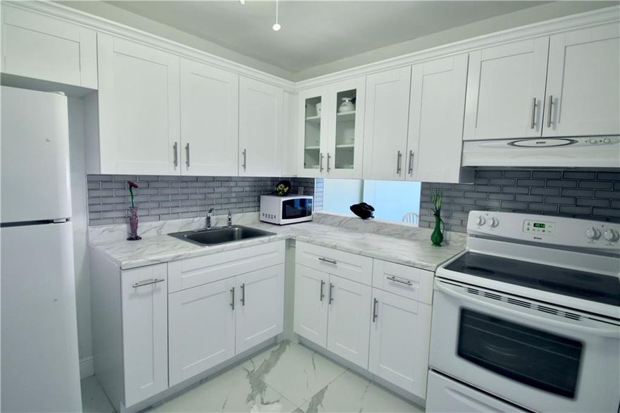 Beautiful and completely remodeled 1 bedroom, 1 bath condo. Move-in ready. New white shaker cabinets, white granite counters, grey subway tile backsplash. Large ceramic marble tile flooring throughout. Bathroom has new vanity, new toilet, and excellent new shower. 3rd floor unit has elevator access. Window and patio have hurricane protection. Everything is ready to go, just move in! Lots of activities available. Pool, clubhouse and lake are just steps away. Convenient to I-95, airport, beach, dining and shopping. 55+ community.