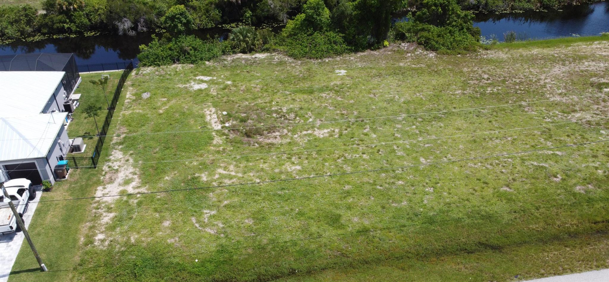 Are you ready to build your dream home? If so, this vacant residential land (lot 85 + 86) for sale sits in a nice area ready to build a single-family home. Per previous owners, the builder prepared an Area Tabulation as follows: Living 1,718, garage 435, lanai 157, entry 37, with a total square foot of 2,347 (all measurements are approximate, and other information must be verified). These lots offer a Seawall that was built in 2005. One of the best parts of living in Cape Coral, Florida is their beautiful beaches, such as Sanibel Island! From gorgeous seaside parks to dog-friendly hikes and much more! Cape Coral has it all! Cape Coral is fast-growing and awaits you.