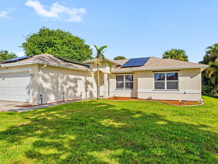 Welcome to this beautiful 3-bed/2-bath home located in PSL. Enjoy nearby dining, shopping, & access to I-95. Home features spacious 2-car garage, vaulted ceilings, updated ceiling fans, & durable tile throughout. Updated kitchen, soft-close cabinets with dovetail drawers, granite countertops, & sleek stainless steel appliances—perfect for everyday use or entertaining. Generously sized bedrooms and a large utility room for added convenience. Elegant French doors open up to a covered porch and leads out to a large backyard, offering plenty of space for kids to play or to add a future pool, oversized driveway, updated roof & AC, water heater 2018, and energy-efficient solar panels. County water, septic system, and no HOA fees, home offers comfort and freedom. A lovely place to call home.