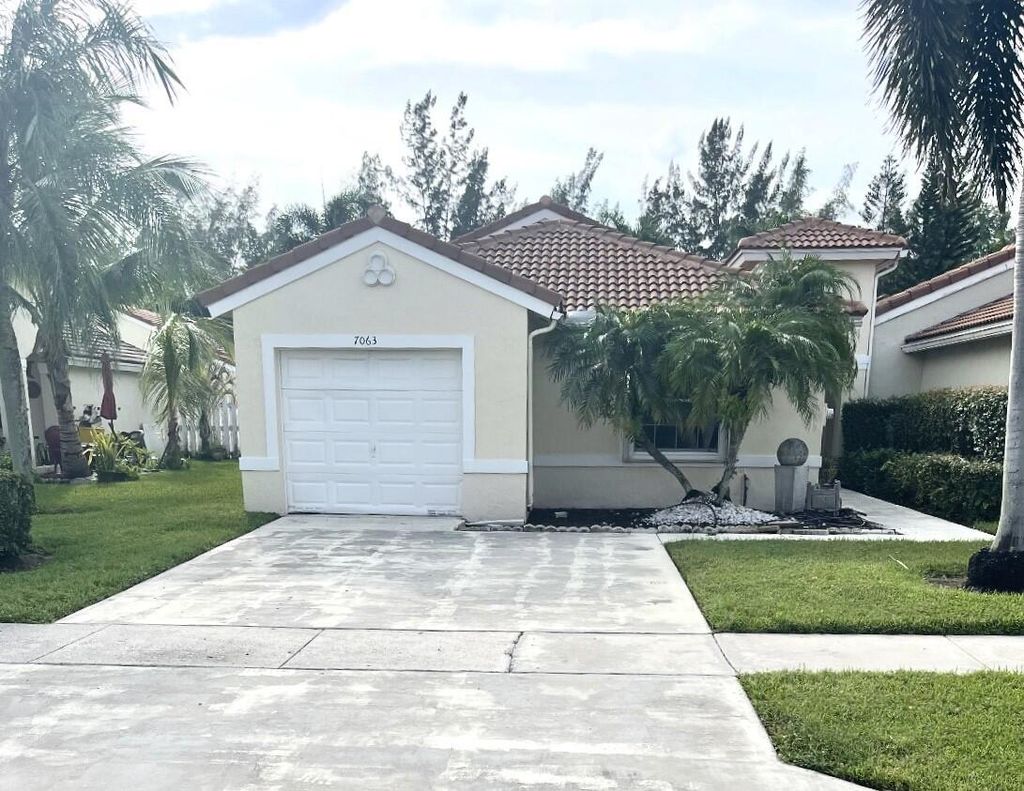 Photo of 7063 Burgess Drive, Greenacres, FL 33467 (MLS # B26034899)