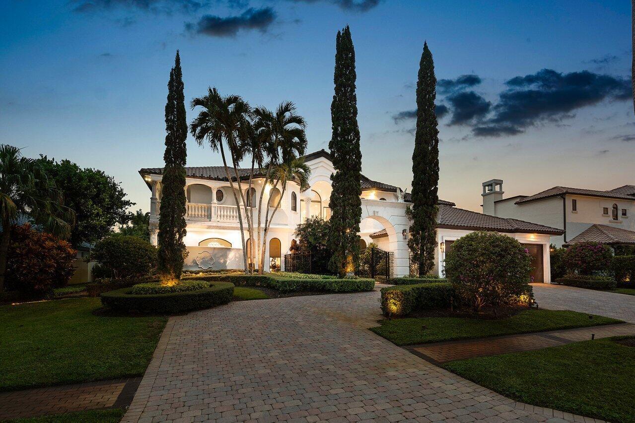 Experience breathtaking long lake views from this grand estate in the prestigious St. Andrews Country Club. Sophisticated & elegant, this home offers over 7,100 sq ft of open, light-filled living space with 5 bedrooms, 7.5 baths, a private office, home theater, fitness room and a versatile bonus room. Designed for both comfort and luxury, the home boasts high ceilings, impact glass, an elevator for convenience, and a full house generator. The first-floor primary suite features dual bathrooms & custom expansive closets. Enjoy seamless entertaining indoors and out with a covered lanai, summer kitchen, pool and spa. St Andrews offers world-class amenities including two 18-hole championship golf courses, resort-style pools, tennis, pickleball, spa /salon, dining and vibrant social events.