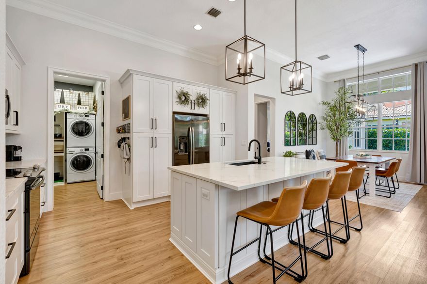 Low HOA ($145/mo!), fully renovated designer Belmont model in the community of Paseos, offering a private preserve-side retreat on a corner lot. This beautifully customized CBS home features 3 bedrooms, 2 full bathrooms, a powder room, a den/study, and a two-car garage across 2,185 sq ft of living space (3,134 total). This beautifully customized CBS home features 3 bedrooms, 2 full bathrooms, a powder room, a den/study, and a two-car garage across 2,185 sq ft of living space (3,134 total). Thoughtfully upgraded for modern South Florida living, it combines soaring 12-foot ceilings in the main areas, luxury vinyl flooring, crown molding, and custom woodwork.  The gourmet kitchen (2020) boasts quartz countertops, a 7.5' center island, solid wood soft-close cabinetry, double pantry storage,   matte black hardware and matching Black Slate appliances. Interior upgrades include designer-renovated bathrooms, custom built-ins, a striking slat wall media center with built-in speakers, smart home features including Ring and Nest, and fresh interior paint (2026).  Outdoor living shines with an extended marble tile patio (2024), redesigned landscaping, expanded yard space, and added privacy, complemented by fresh exterior paint. Paseos residents enjoy resort-style amenities including a beach-entry pool, tennis / pickleball courts, scenic walking nature trails throughout the neighborhood (super cool), two playgrounds, and a newly refurbished clubhouse, all just minutes from beaches, dining, shopping, and downtown West Palm Beach, Palm Beach Gardens, and Palm Beach Island.