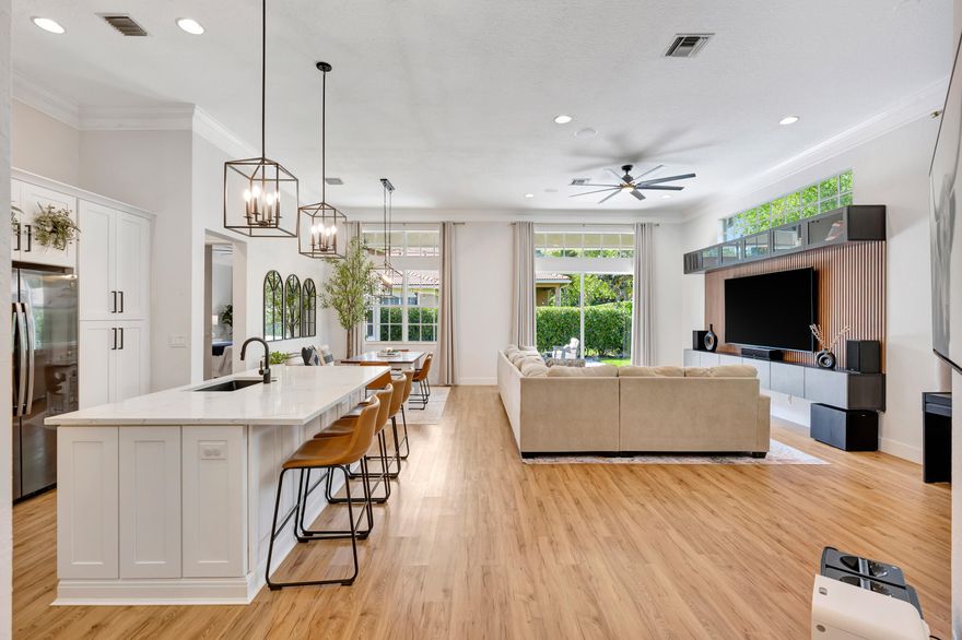 Fully renovated designer Belmont model in the community of Paseos, offering a private preserve-side retreat on a corner lot. This beautifully customized CBS home features 3 bedrooms, 2 full bathrooms, a powder room, a den/study, and a two-car garage across 2,185 sq ft of living space (3,134 total). This beautifully customized CBS home features 3 bedrooms, 2 full bathrooms, a powder room, a den/study, and a two-car garage across 2,185 sq ft of living space (3,134 total). Thoughtfully upgraded for modern South Florida living, it combines soaring 12-foot ceilings in the main areas, luxury vinyl flooring, crown molding, and custom woodwork.  The gourmet kitchen (2020) boasts quartz countertops, a 7.5' center island, solid wood soft-close cabinetry, double pantry storage, matte black hardware   and matching Black Slate appliances. Interior upgrades include designer-renovated bathrooms, custom built-ins, a striking slat wall media center with built-in speakers, smart home features including Ring and Nest, and fresh interior paint (2026).  Outdoor living shines with an extended marble tile patio (2024), redesigned landscaping, expanded yard space, and added privacy, complemented by fresh exterior paint. Paseos residents enjoy resort-style amenities including a beach-entry pool, tennis and pickleball courts, scenic nature trails, two playgrounds, and a newly refurbished clubhouse, all just minutes from beaches, dining, shopping, and downtown West Palm Beach, Palm Beach Gardens, and Palm Beach Island.