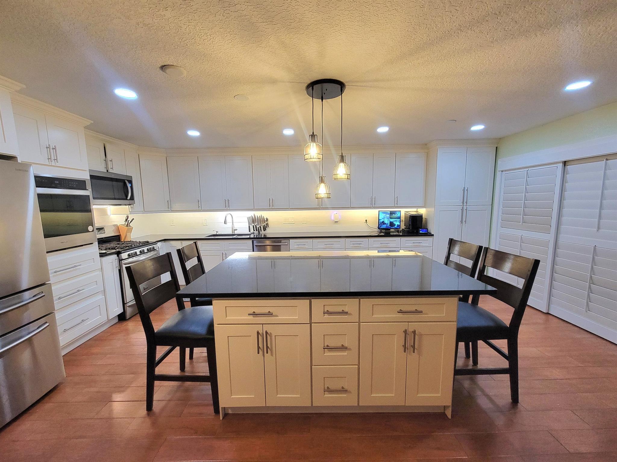 Adorable, Cozy and thoughtfully updated 3BR/2.5B townhouse in the heart of West Palm Beach! This efficient floor plan has been enhanced with quality upgrades throughout. Enjoy a brand-new roof (2025), new bedroom flooring (2025), fresh paint, and an updated kitchen with natural gas for the stove, grill, dryer, and water heater--a savings on monthly electric bills! A large outdoor shed with separate access into the courtyard offers unique storage or space for a motorcycle. Additional highlights include accordion hurricane shutters, newer tankless, gas water heater, Ring cameras and security monitor conveys. Jetted tub in master, double sinks in both bathrooms and real hard wood floors on stairs. stainless steel appliance, granite countertops, soft close drawers, build in soda stream...