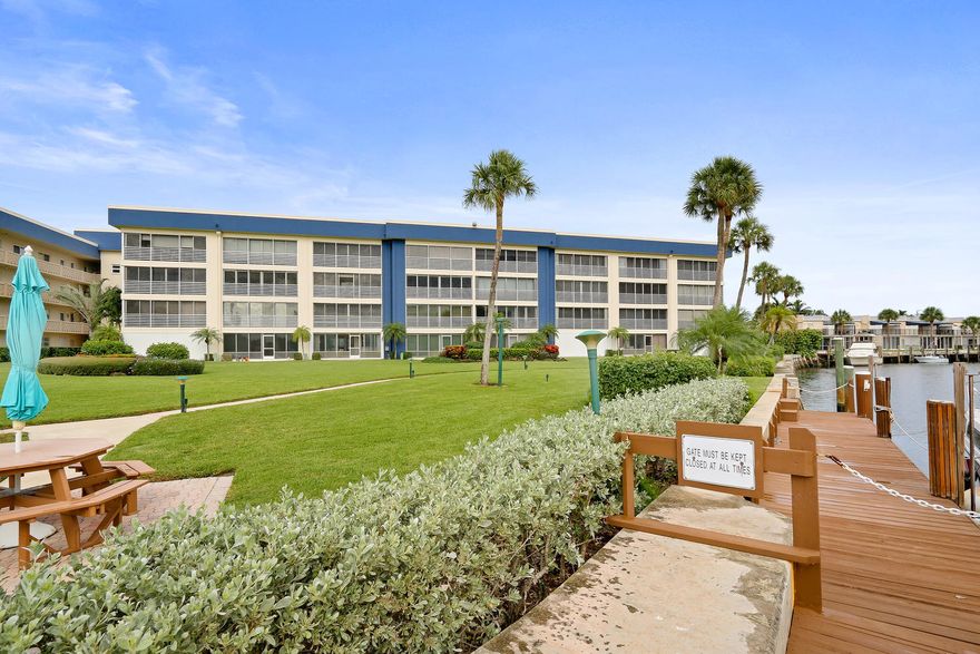 JUST REDUCED!  Lowest priced direct waterfront unit! Experience the million-dollar boating lifestyle at a fraction of the price with this amazing first-floor condo. Enjoy the Intracoastal views right from your living room.  Step outside your back door onto lushly landscaped grass, and right to the edge of beautiful private boat docks, available to you for much less than other area marinas. The interior of the condo is lightly lived in with recently updated kitchen, carpeting, accordion hurricane shutters, and water heater.  Have peace of mind with a 2 year old A/C system.  Tropic Harbor has many active adult activities such as group golf outings, cruises, shuffleboard tournaments and more!  This home is perfect for a seasonal ''lock and go'' getaway or a full-time tropical residence